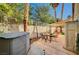 Backyard patio with table, chairs, and hot tub at 3464 Trilogy Dr, Las Vegas, NV 89108