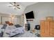 Main bedroom with wood-look floors, ceiling fan, and a mini-fridge at 3464 Trilogy Dr, Las Vegas, NV 89108