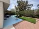 Spacious backyard with lush landscaping, patio area, and a refreshing pool at 5882 W Viking Rd, Las Vegas, NV 89103