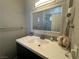 Bright bathroom with white vanity, updated fixtures, and decorative accents at 5882 W Viking Rd, Las Vegas, NV 89103