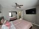 Bedroom with ceiling fan and large TV at 5882 W Viking Rd, Las Vegas, NV 89103