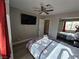 Bedroom with ceiling fan, TV and red curtains at 5882 W Viking Rd, Las Vegas, NV 89103