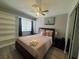 Cozy bedroom featuring a queen bed, ceiling fan, and built in storage at 5882 W Viking Rd, Las Vegas, NV 89103