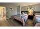 Inviting bedroom with neutral paint, light laminate floors, and comfortable beds at 5882 W Viking Rd, Las Vegas, NV 89103