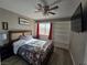 Bedroom with ceiling fan, TV and built in shelving at 5882 W Viking Rd, Las Vegas, NV 89103