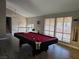 Game room with pool table, hardwood floors, and staircase at 5882 W Viking Rd, Las Vegas, NV 89103