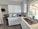 White kitchen cabinets, quartz countertop and stainless steel sink at 5882 W Viking Rd, Las Vegas, NV 89103