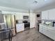 Updated kitchen with stainless steel appliances and white cabinets at 5882 W Viking Rd, Las Vegas, NV 89103