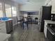 Modern kitchen with stainless steel appliances and breakfast bar at 5882 W Viking Rd, Las Vegas, NV 89103