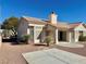 Charming backyard with gravel landscaping, concrete patio, and a view of the house at 11037 Hawk Valley Ave, Las Vegas, NV 89134