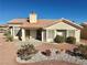 Single-story house with a terracotta tile roof and desert landscaping at 11037 Hawk Valley Ave, Las Vegas, NV 89134