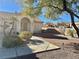 House exterior showcasing the front entrance with walkway and desert landscaping at 11037 Hawk Valley Ave, Las Vegas, NV 89134