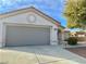 One story house with gray garage door and desert landscaping at 11037 Hawk Valley Ave, Las Vegas, NV 89134