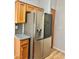 Kitchen features stainless steel refrigerator and wood cabinets at 11037 Hawk Valley Ave, Las Vegas, NV 89134