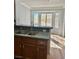 Kitchen with granite counters, wood cabinets, and breakfast bar at 11037 Hawk Valley Ave, Las Vegas, NV 89134