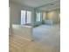 Bright living room with neutral carpet and paint, featuring a half wall detail and lots of natural light at 11037 Hawk Valley Ave, Las Vegas, NV 89134