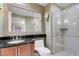 Bathroom with dark vanity, toilet and glass shower at 145 E Harmon Ave # 2321, Las Vegas, NV 89109