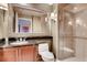 Bathroom with a toilet, sink, and shower, featuring wood cabinets at 145 E Harmon Ave # 2321, Las Vegas, NV 89109