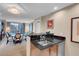 Modern kitchen with breakfast bar and view into living room at 145 E Harmon Ave # 2321, Las Vegas, NV 89109