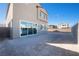 Large backyard with gravel and sliding glass doors at 1722 Game Garden Rd, North Las Vegas, NV 89031