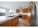 Modern kitchen with wood cabinets and quartz countertops at 1722 Game Garden Rd, North Las Vegas, NV 89031