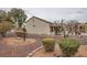 Backyard view of the home, a covered patio area, and desert landscaping at 3005 Noblesville Ct, Henderson, NV 89052