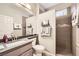 Well-lit bathroom features a walk-in shower, grey vanity and sink with tile flooring at 3005 Noblesville Ct, Henderson, NV 89052