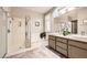 Bathroom featuring double sinks, shower, bathtub, neutral paint, and granite countertops at 3005 Noblesville Ct, Henderson, NV 89052