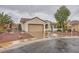 Attractive single-story home with tile roof, two-car garage, desert landscaping and mature palm tree at 3005 Noblesville Ct, Henderson, NV 89052