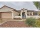 Inviting single-story home with tile roof, two-car garage and desert landscaping for easy maintenance at 3005 Noblesville Ct, Henderson, NV 89052