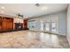 Open concept living area features tile floors, natural light, fireplace and patio doors at 3005 Noblesville Ct, Henderson, NV 89052