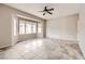 Spacious living room featuring a ceiling fan, tile flooring, and a large bay window at 3005 Noblesville Ct, Henderson, NV 89052