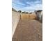 Large, unlandscaped backyard with block wall and gate at 427 E Barrett St, Henderson, NV 89011