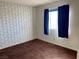 Bedroom with patterned wallpaper and dark carpet at 427 E Barrett St, Henderson, NV 89011