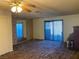 Spacious living room with sliding glass doors and mirrored wall at 427 E Barrett St, Henderson, NV 89011