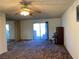 Spacious living room with sliding glass doors and piano at 427 E Barrett St, Henderson, NV 89011