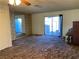 Bright living room with sliding glass doors and mirrored wall at 427 E Barrett St, Henderson, NV 89011