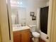 Bathroom with a vanity, toilet, and shower-tub combination with a dark curtain at 5330 E Charleston Blvd # 5, Las Vegas, NV 89142