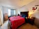 Carpeted bedroom featuring a red plaid comforter and light-blocking curtains at 5330 E Charleston Blvd # 5, Las Vegas, NV 89142