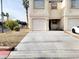 Charming townhouse featuring a one car garage with a spacious concrete driveway at 5330 E Charleston Blvd # 5, Las Vegas, NV 89142