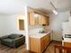 Cozy kitchen with wood cabinets, white appliances, and ample counter space adjacent to the living room at 5330 E Charleston Blvd # 5, Las Vegas, NV 89142