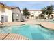 Community pool featuring a bright blue pool with nearby lounge chairs and community structures at 5330 E Charleston Blvd # 5, Las Vegas, NV 89142