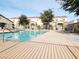 Community pool area with lounge chairs, with a bright blue pool and buildings in the background at 5330 E Charleston Blvd # 5, Las Vegas, NV 89142