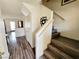 Open staircase featuring wood steps, white railing, and a view of the entryway, enhancing the home's character at 5330 E Charleston Blvd # 5, Las Vegas, NV 89142