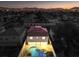 Aerial view of house, pool, and surrounding homes at dusk at 686 Ribbon Grass Ave, Las Vegas, NV 89183