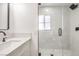 Modern bathroom with white vanity, quartz countertop, and glass shower at 686 Ribbon Grass Ave, Las Vegas, NV 89183