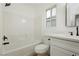 Updated bathroom with white vanity, quartz countertop, and a bathtub at 686 Ribbon Grass Ave, Las Vegas, NV 89183