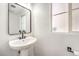 Clean bathroom featuring a pedestal sink and black matte fixtures at 686 Ribbon Grass Ave, Las Vegas, NV 89183