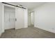 Spacious bedroom with a barn door and closet at 686 Ribbon Grass Ave, Las Vegas, NV 89183