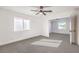 Spacious bedroom with ceiling fan and grey carpeting at 686 Ribbon Grass Ave, Las Vegas, NV 89183